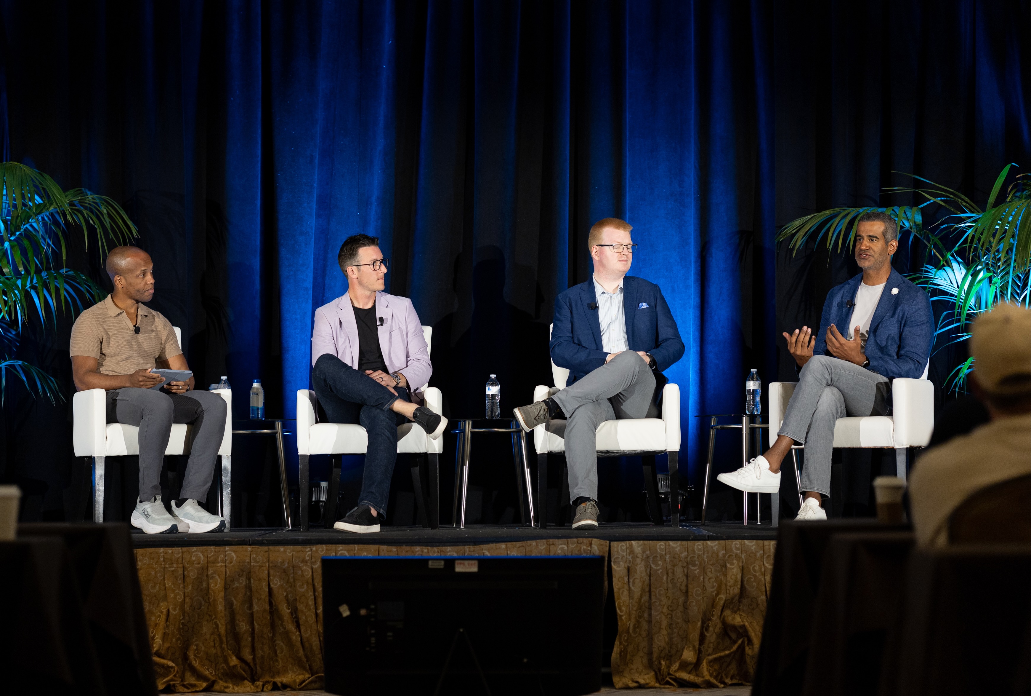 Daniel Paulino, seated at right, speaking on a panel at AIM